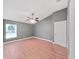 Grey bedroom showcasing vaulted ceiling, light wood floors, and a ceiling fan at 2405 Dakota Rock Dr, Ruskin, FL 33570
