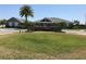 Community clubhouse featuring manicured lawn, mature palm trees, and a welcoming entrance at 2405 Dakota Rock Dr, Ruskin, FL 33570