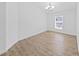 Bright dining room featuring wood floors, a modern light fixture and large window at 2405 Dakota Rock Dr, Ruskin, FL 33570