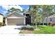 Charming single-story home featuring a well-manicured lawn and a two-car garage with beautiful landscaping at 2405 Dakota Rock Dr, Ruskin, FL 33570
