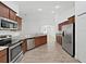 Kitchen featuring stainless steel appliances, granite countertops, and wooden cabinets at 2405 Dakota Rock Dr, Ruskin, FL 33570