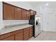 Kitchen featuring stainless steel appliances, granite countertops, and wooden cabinets at 2405 Dakota Rock Dr, Ruskin, FL 33570