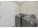 Convenient laundry room featuring modern washer and dryer units with wire shelving at 2405 Dakota Rock Dr, Ruskin, FL 33570
