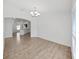 Spacious living room with light wood floors, white walls, and modern lighting fixtures at 2405 Dakota Rock Dr, Ruskin, FL 33570