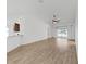 Bright, open living room with light wood floors, white walls, and modern ceiling fan at 2405 Dakota Rock Dr, Ruskin, FL 33570