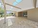 Relaxing covered patio featuring skylights, brick flooring, and a sliding glass door entry at 2405 Dakota Rock Dr, Ruskin, FL 33570