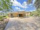 Spacious covered patio featuring brick flooring and a landscaped yard at 2405 Dakota Rock Dr, Ruskin, FL 33570