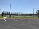 Community tennis courts featuring professional fencing, lighting, and court-side seating at 2405 Dakota Rock Dr, Ruskin, FL 33570