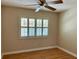 Bright, sunny bedroom with wood floors and plantation shutters on the windows allows for plenty of natural light at 2567 Oakleaf Ln # 41B, Clearwater, FL 33763
