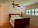 Inviting bedroom with hardwood floors, a comfortable bed, and plantation shutters offering plenty of natural light at 2567 Oakleaf Ln # 41B, Clearwater, FL 33763