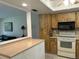 Charming kitchen featuring wooden cabinets, modern appliances, and a convenient breakfast bar overlooking the living area at 2567 Oakleaf Ln # 41B, Clearwater, FL 33763