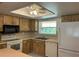 Bright kitchen with ample cabinet space, modern appliances including a refrigerator and dishwasher, and a sunny window at 2567 Oakleaf Ln # 41B, Clearwater, FL 33763