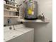 Functional laundry room with washer, dryer, shelves, and water heater provides a convenient space at 2567 Oakleaf Ln # 41B, Clearwater, FL 33763
