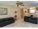 Comfortable living room featuring tile floors, contemporary sofas, and a charming view into the adjacent kitchen at 2567 Oakleaf Ln # 41B, Clearwater, FL 33763