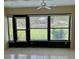 Sunroom features tile flooring, large windows with outside views and a ceiling fan at 2567 Oakleaf Ln # 41B, Clearwater, FL 33763