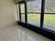 Bright sunroom featuring tiled floor and windows providing plentiful natural light and scenic outdoor views at 2567 Oakleaf Ln # 41B, Clearwater, FL 33763