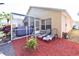 Landscaped backyard featuring a screened patio and lounge chairs at 2604 Clareside Dr, Valrico, FL 33596