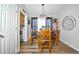 Cozy dining room with wood table, four chairs, chandelier, and view to laundry room at 2604 Clareside Dr, Valrico, FL 33596