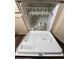 The dishwasher is open, revealing a clean interior with racks and spray arms at 2604 Clareside Dr, Valrico, FL 33596