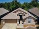 Aerial view of a single-Gathering home with a well-maintained roof and manicured landscaping at 2604 Clareside Dr, Valrico, FL 33596