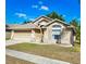 Charming single-Gathering home featuring a well-manicured lawn and a welcoming two-car garage at 2604 Clareside Dr, Valrico, FL 33596