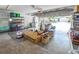 Cluttered garage view with shelves, boxes, tools, and the garage door open to the outside at 2604 Clareside Dr, Valrico, FL 33596