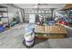 A cluttered garage includes storage shelves, tools, boxes, and various household items at 2604 Clareside Dr, Valrico, FL 33596