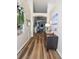 Charming hallway featuring hardwood floors, a decorative mirror, and a glimpse into the open-concept living spaces at 2604 Clareside Dr, Valrico, FL 33596