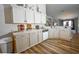 Well-lit kitchen featuring bright countertops, white cabinetry, stainless steel appliances, and hardwood floors at 2604 Clareside Dr, Valrico, FL 33596