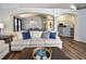 Comfortable living room with wood floors that opens to the dining room and kitchen at 2604 Clareside Dr, Valrico, FL 33596