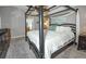 Spacious bedroom features a four-post bed and ensuite bathroom at 2604 Clareside Dr, Valrico, FL 33596
