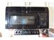 The kitchen has a black microwave installed above the stove at 2604 Clareside Dr, Valrico, FL 33596