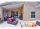 Covered outdoor patio featuring lounge seating and an adjacent dining area at 2604 Clareside Dr, Valrico, FL 33596