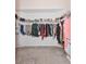 Open walk-in closet providing generous storage with shelves, hanging rods, and modern carpet floors at 2604 Clareside Dr, Valrico, FL 33596