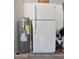 Hot water heater with white refrigerator in the background with fan and pressure washer at 2604 Clareside Dr, Valrico, FL 33596
