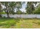 Large, grassy back yard with a white fence for privacy at 3001 Folklore Dr, Valrico, FL 33596