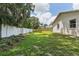 Spacious backyard featuring a privacy fence, mature trees, and a well-maintained lawn at 3001 Folklore Dr, Valrico, FL 33596