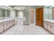 A well-lit bathroom featuring a shower, soaking tub, dual sinks, and ample countertop space at 3001 Folklore Dr, Valrico, FL 33596
