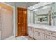 A bright bathroom featuring a single sink, walk in shower, large mirror and ample counterspace at 3001 Folklore Dr, Valrico, FL 33596