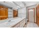 An open bathroom featuring dual sinks, tile flooring, a shower, and neutral tones at 3001 Folklore Dr, Valrico, FL 33596