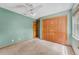 A quaint bedroom with plush carpeting, a ceiling fan, natural light, and built in closet at 3001 Folklore Dr, Valrico, FL 33596