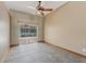 Bedroom with tiled floor, sliding glass doors to the backyard, and a ceiling fan at 3001 Folklore Dr, Valrico, FL 33596