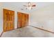 Bedroom with carpet, ceiling fan, closet and solid wood door at 3001 Folklore Dr, Valrico, FL 33596