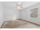 Neutral bedroom featuring carpet, ceiling fan and small window at 3001 Folklore Dr, Valrico, FL 33596