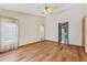 A cozy bedroom featuring hardwood floors, natural light, and a ceiling fan at 3001 Folklore Dr, Valrico, FL 33596