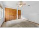 Bedroom features carpet, ceiling fan and closet with wood doors at 3001 Folklore Dr, Valrico, FL 33596