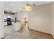 Dining area with decorative lighting, open to the kitchen, and view of the living room at 3001 Folklore Dr, Valrico, FL 33596
