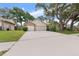 Suburban home featuring a wide driveway leading to a two-car garage and well-maintained lawn at 3001 Folklore Dr, Valrico, FL 33596