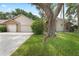 Suburban home featuring a wide driveway leading to a two-car garage and well-maintained lawn at 3001 Folklore Dr, Valrico, FL 33596