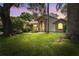 Charming single-story home featuring a brick archway, lush lawn, and mature trees at 3001 Folklore Dr, Valrico, FL 33596